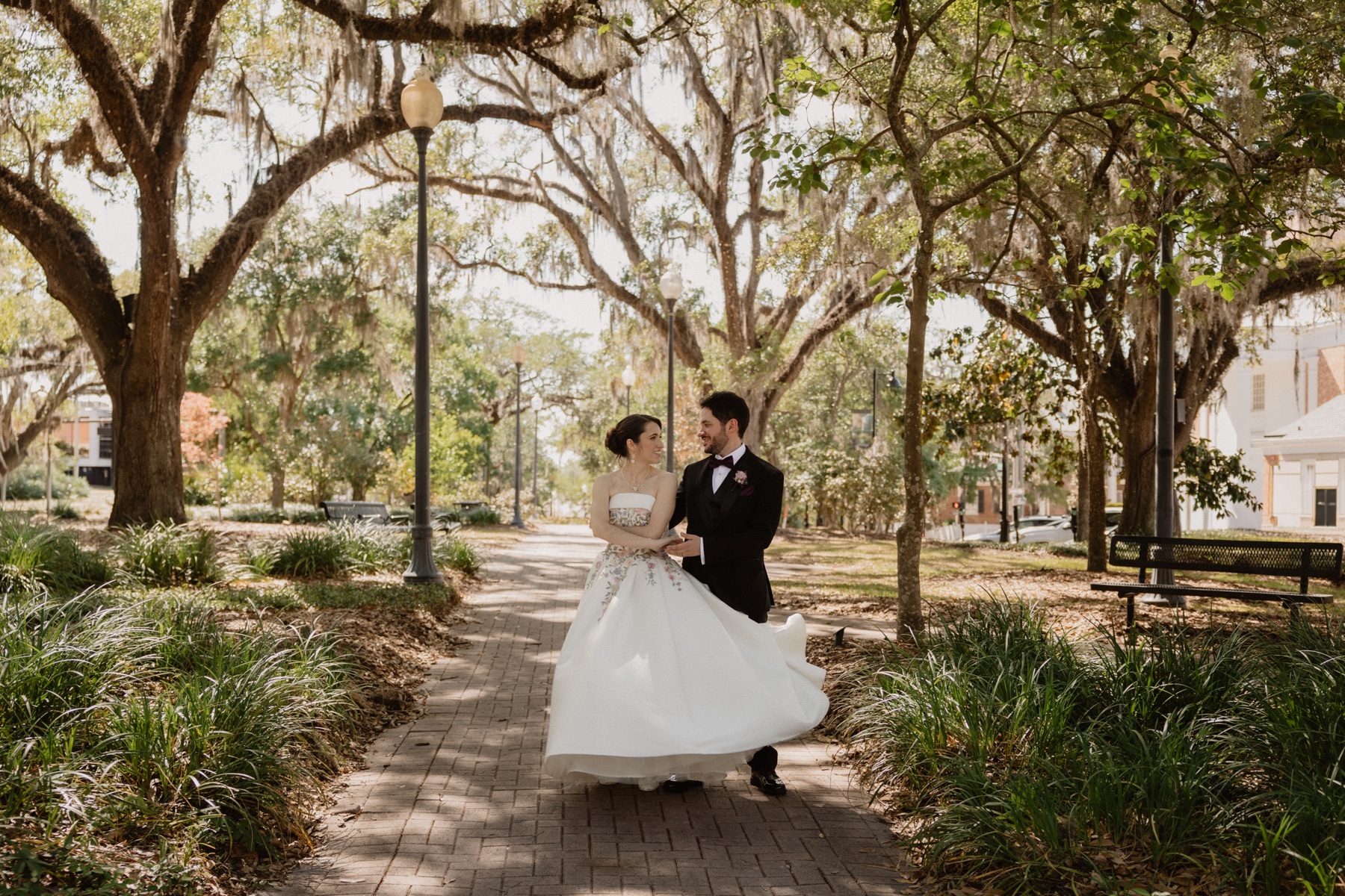 Bride and groom dancing under spanish moss in a Florida park